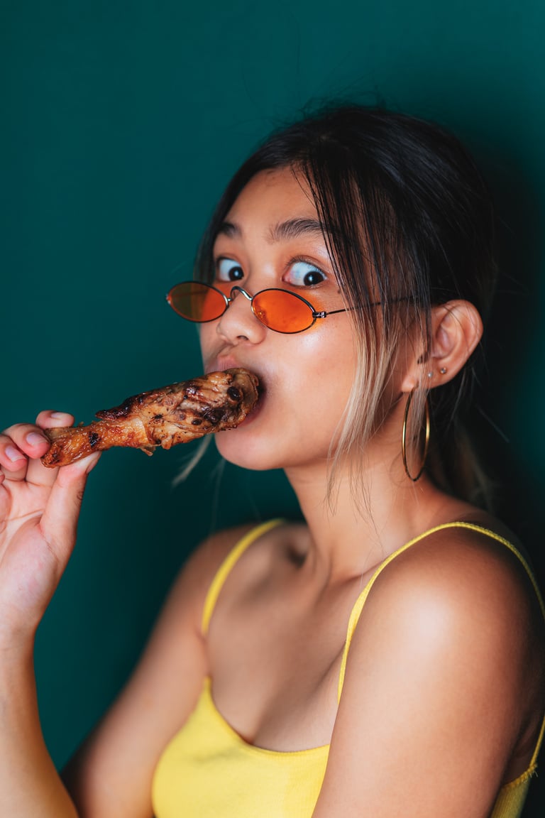 Woman Eating Chicken Barbecue